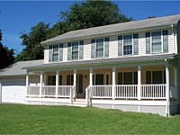 <b>Porch addition to home using composite deck boards, square vinyl columns, vinyl railing, fascia and lattice wrap around the bottom of the porch</b>